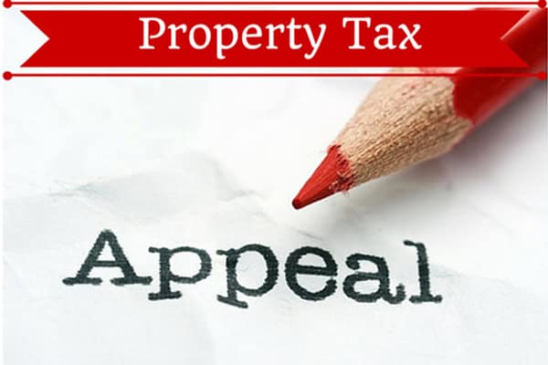 Property tax appeal document with red pencil and 'Appeal' text.