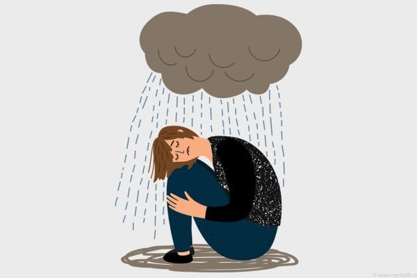 Child sitting on ground with rain falling from dark cloud overhead.