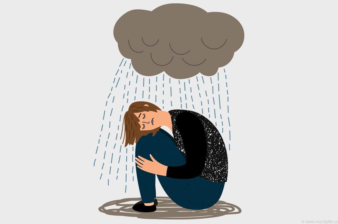 Child sitting on ground with rain falling from dark cloud overhead.